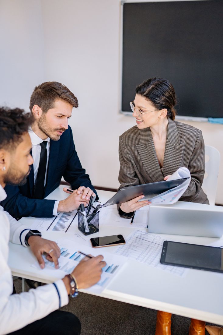 Professionals reviewing project and performance materials during a strategy meeting